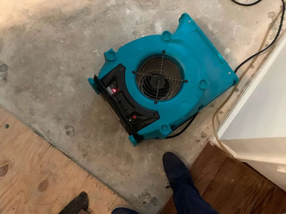 Air mover drying subfloor during Commercial Water Damage Restoration in Miami Springs